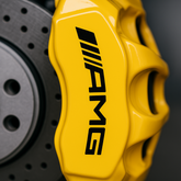 Close-up of a yellow AMG brake caliper with a blurred background