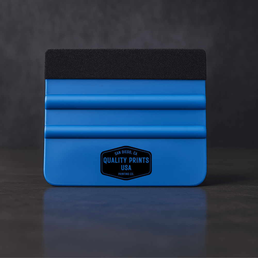 Blue vinyl squeegee tool with black top on a dark background