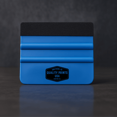 Blue vinyl squeegee tool with black top on a dark background