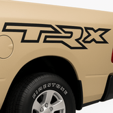 Beige truck with 'TRX' decal on the back