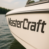 Close-up of a MasterCraft boat on water with a blurred background