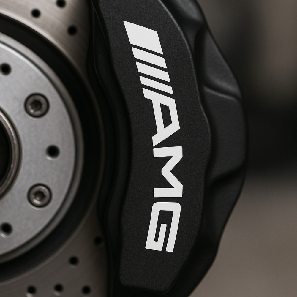 Close-up of a car brake caliper with AMG logo on a blurred background