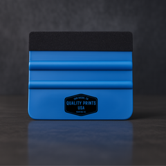 Blue vinyl squeegee tool with black top on a dark background