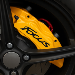 Close-up of a yellow 'Focus' brake caliper on a black background