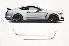 White Ford Mustang with black side graphics on a white background