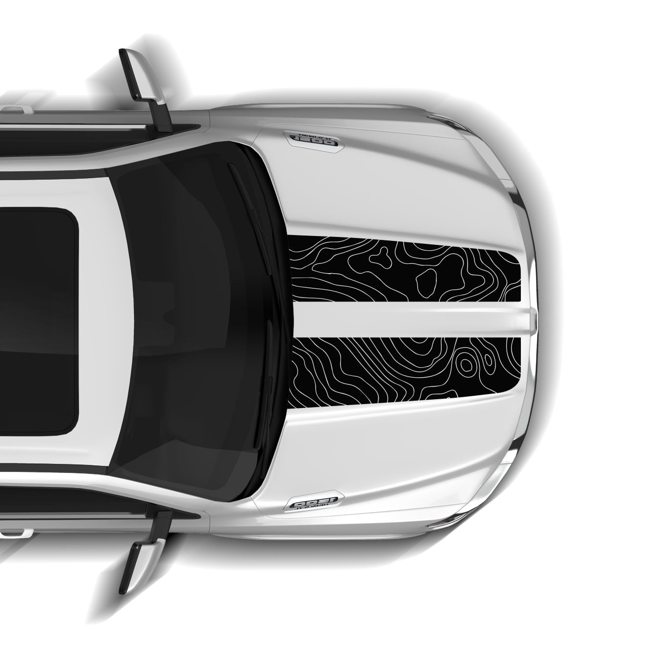 Top-down view of a silver car with a black and white design on the windshield.