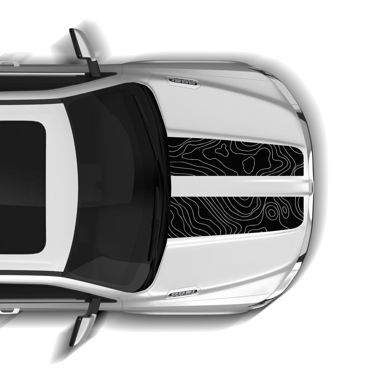 Top-down view of a silver car with a black and white design on the windshield.