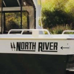 Truck with 'North River' decal on a blurred natural background