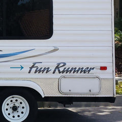 Back of a white travel trailer with 'Fun Runner' branding.