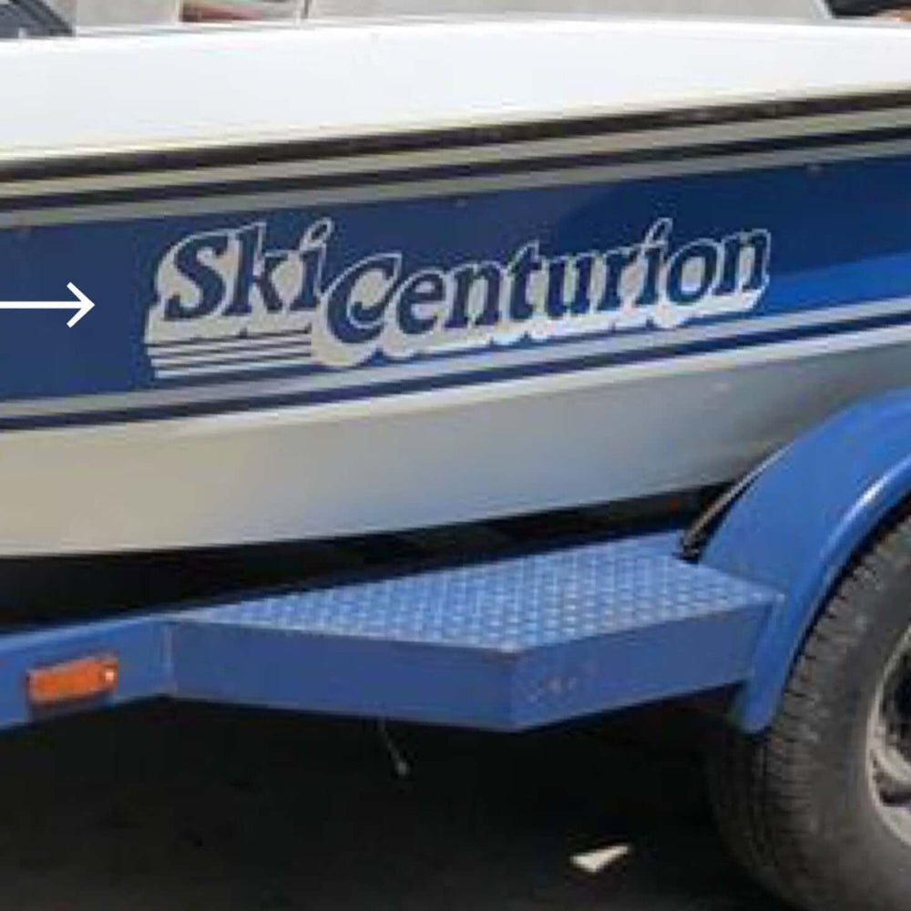 Blue and white boat with 'Ski Centurion' branding on a trailer.