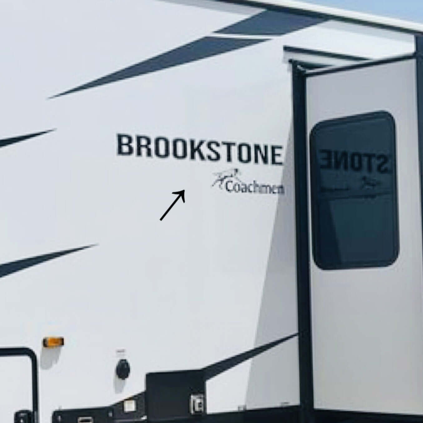 Brookstone RV with branding on a clear day