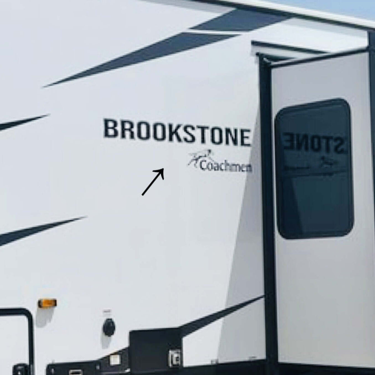 Brookstone RV with branding on a clear day