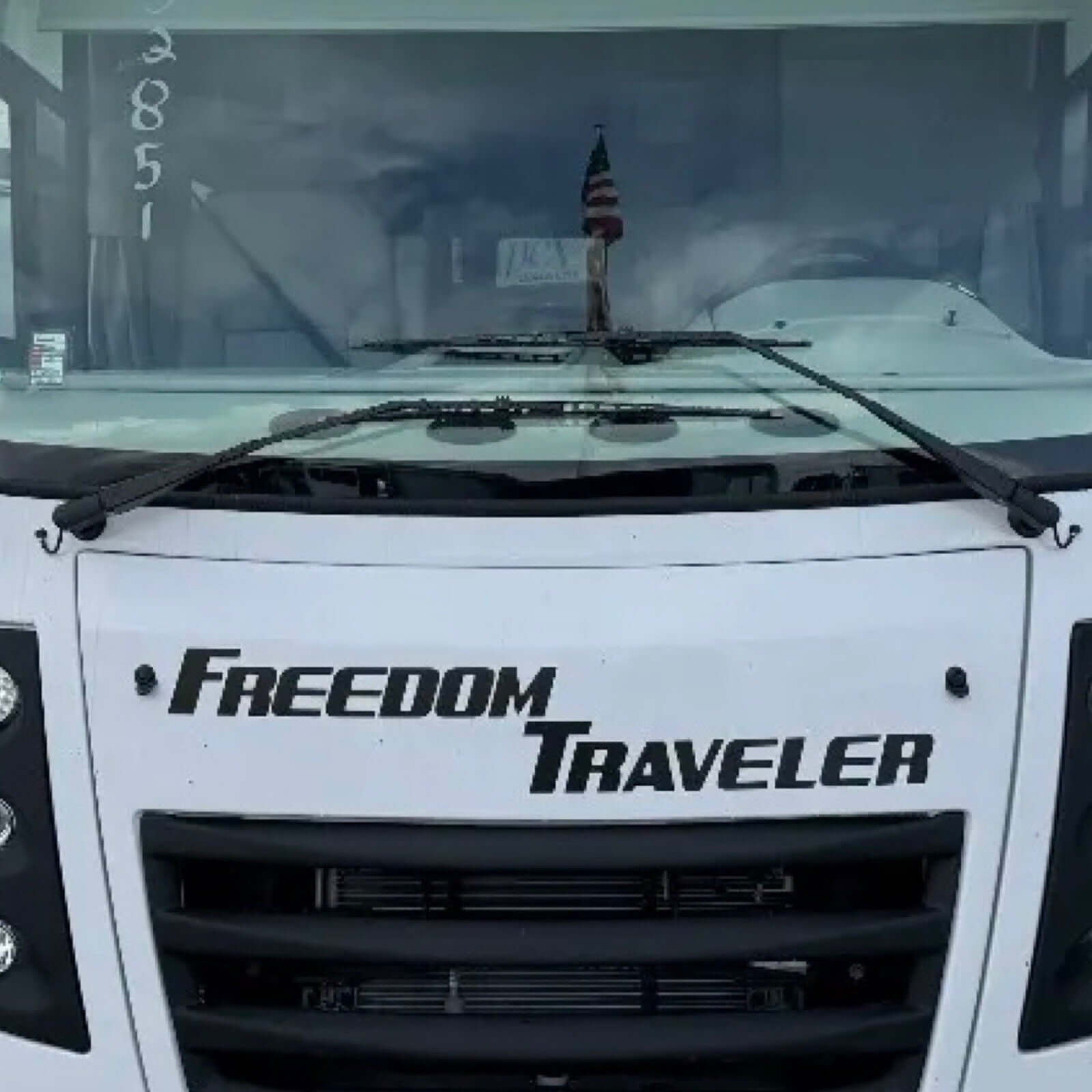Front view of a vehicle with 'Freedom Traveler' branding on the windshield.