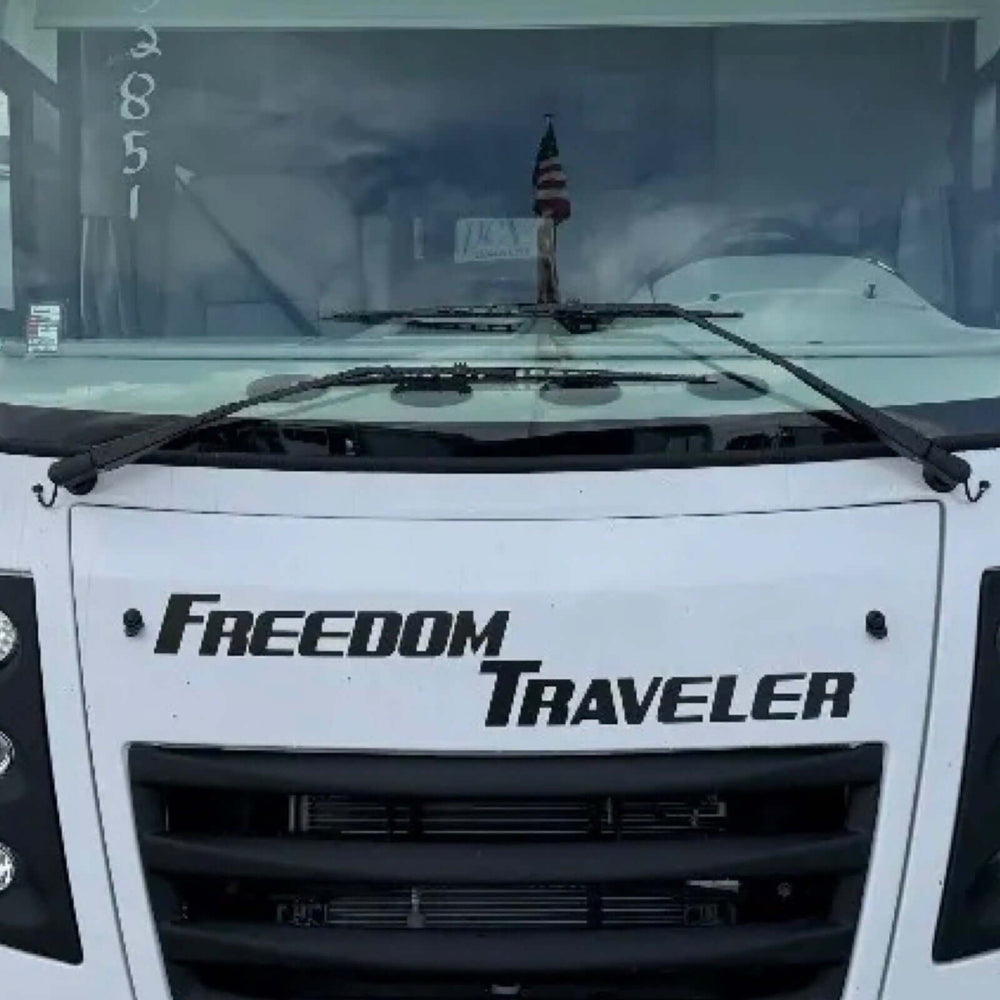 Front view of a vehicle with 'Freedom Traveler' branding on the windshield.