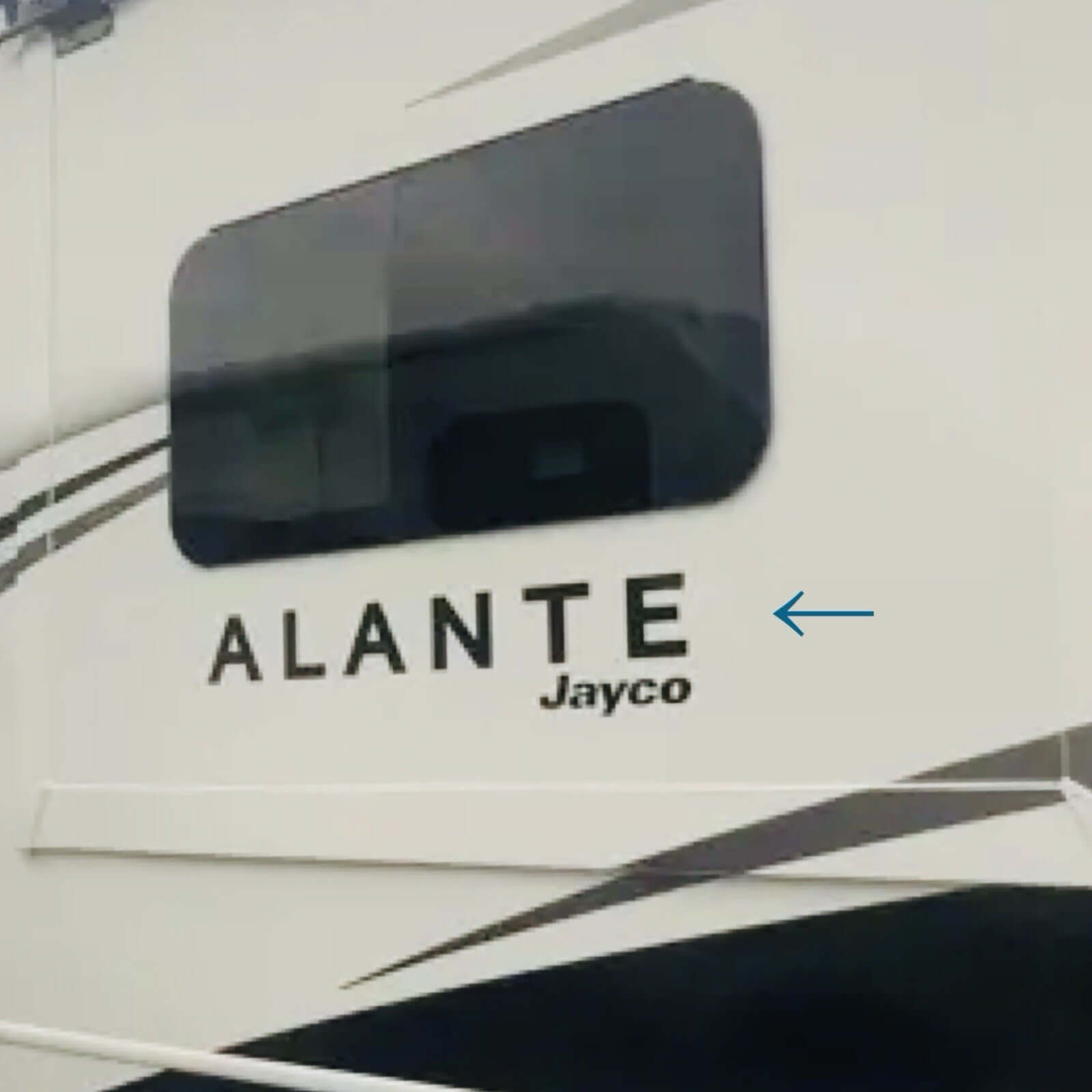 Close-up of a Jayco Alante vehicle with a reflection on the glass.